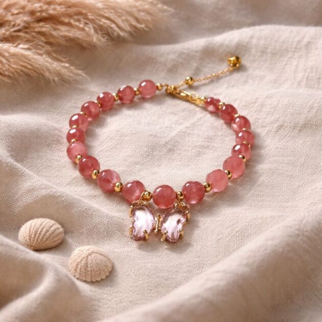 أسوارة خرز وردي بتعليقة فراشات